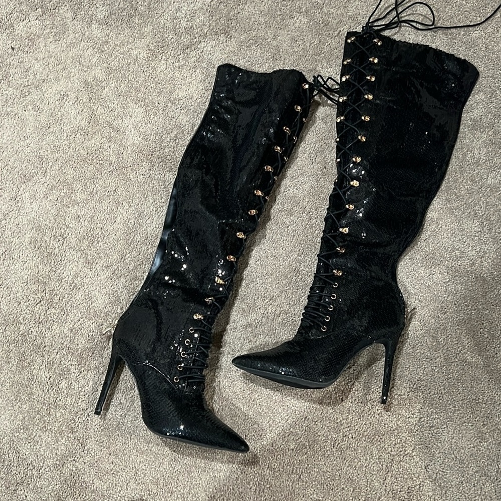 Over-the-knee laced-up sequined boots.